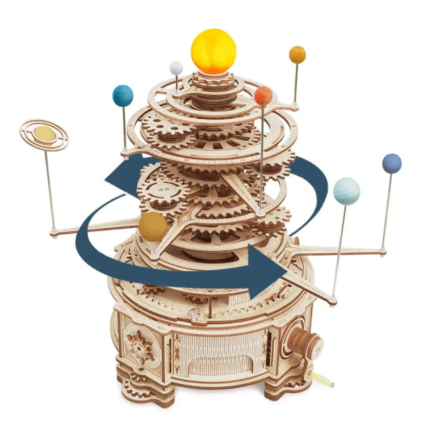 Wooden model of a solar system with planets and gears on a white background